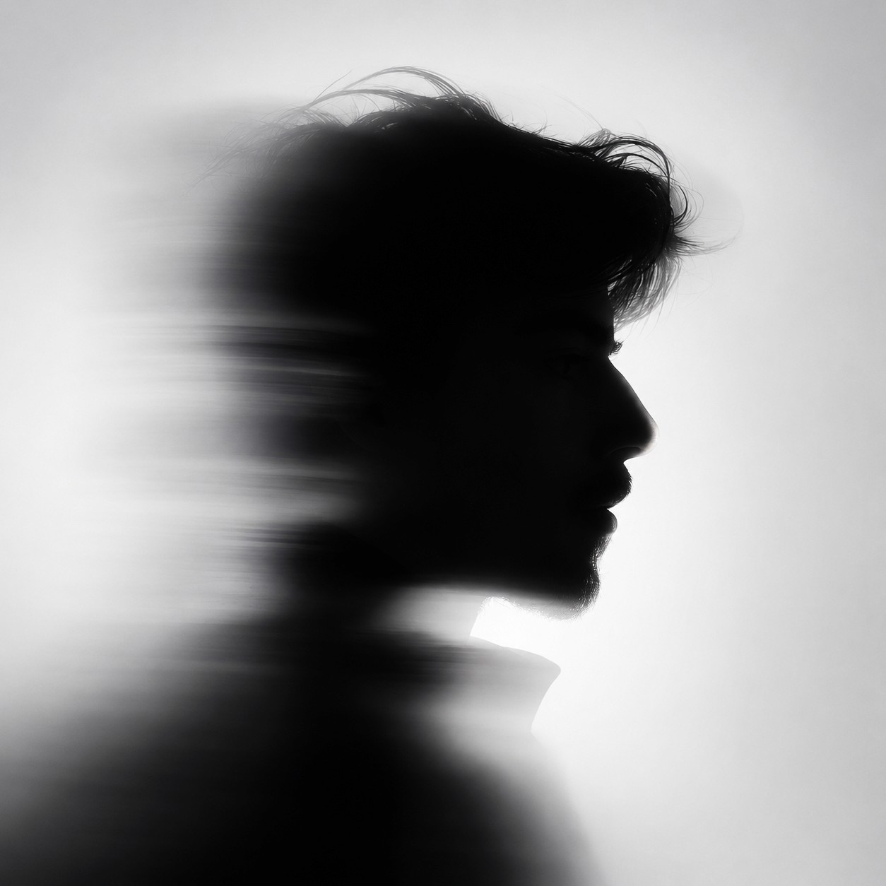 a blurry photo of a person standing in front of a wall